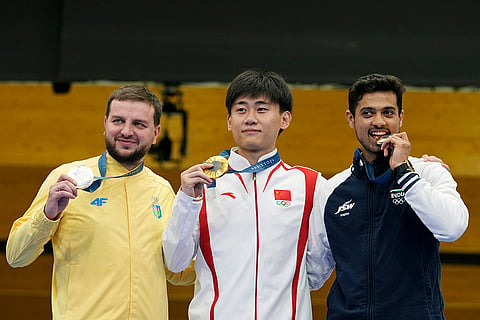 Men's 50m rifle 3 positions: Gold medalist China's Liu Yukun, center, with silver medalist Ukraine's Serhiy Kulish, left, and bronze medalist India's Swapnil Kusale